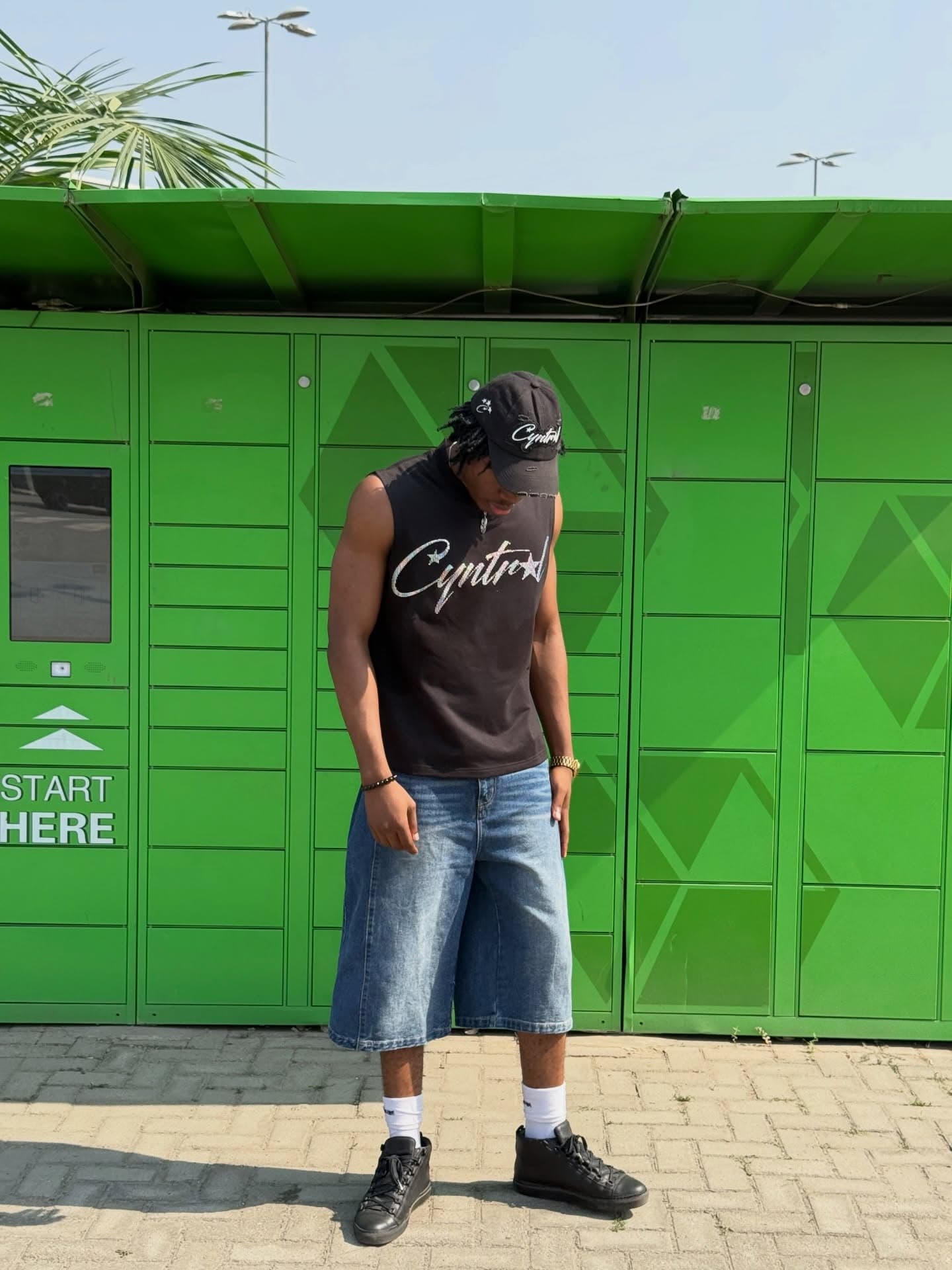 Black tee against bright green wall