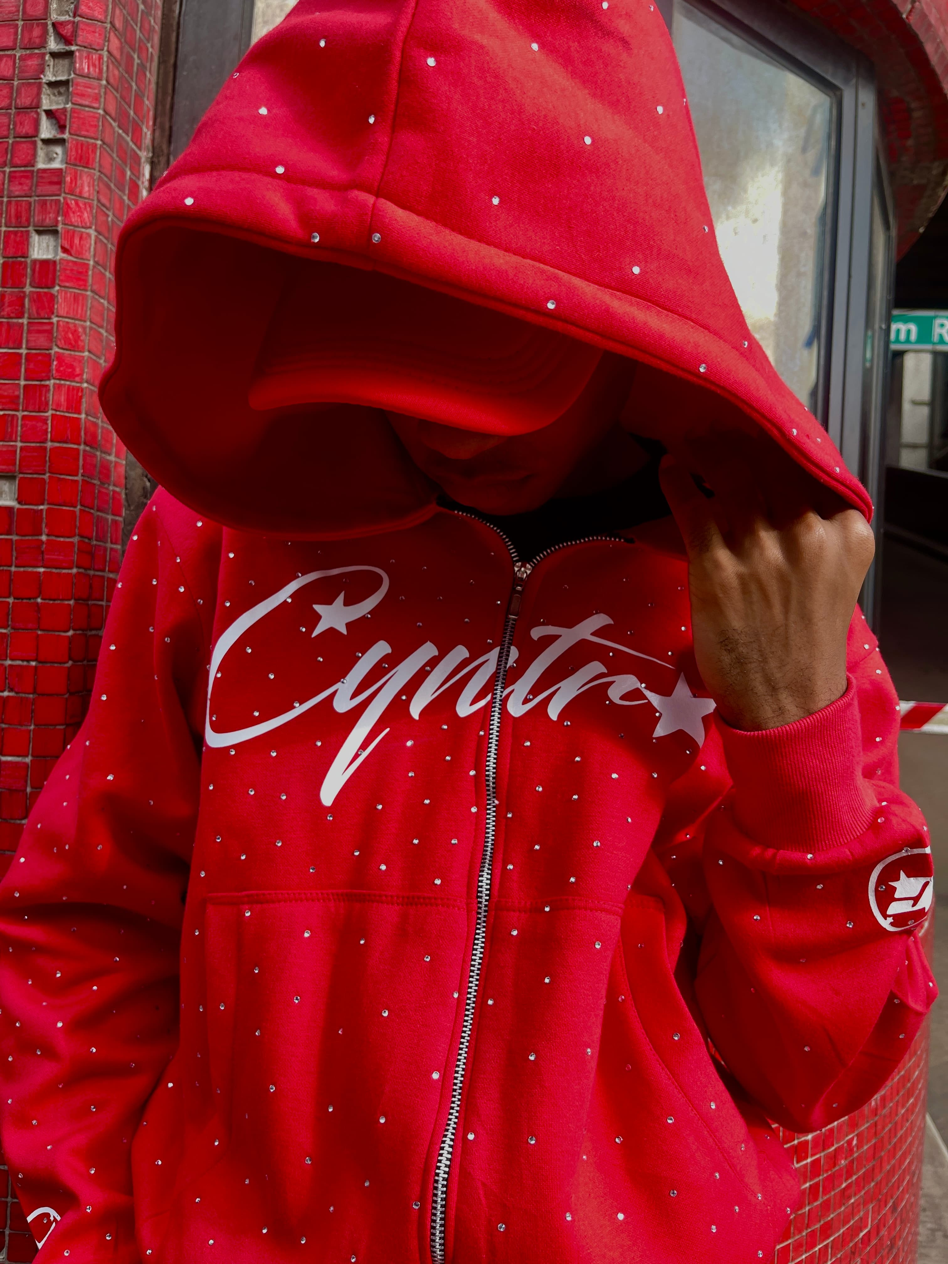 Red hoodie portrait by graffiti wall