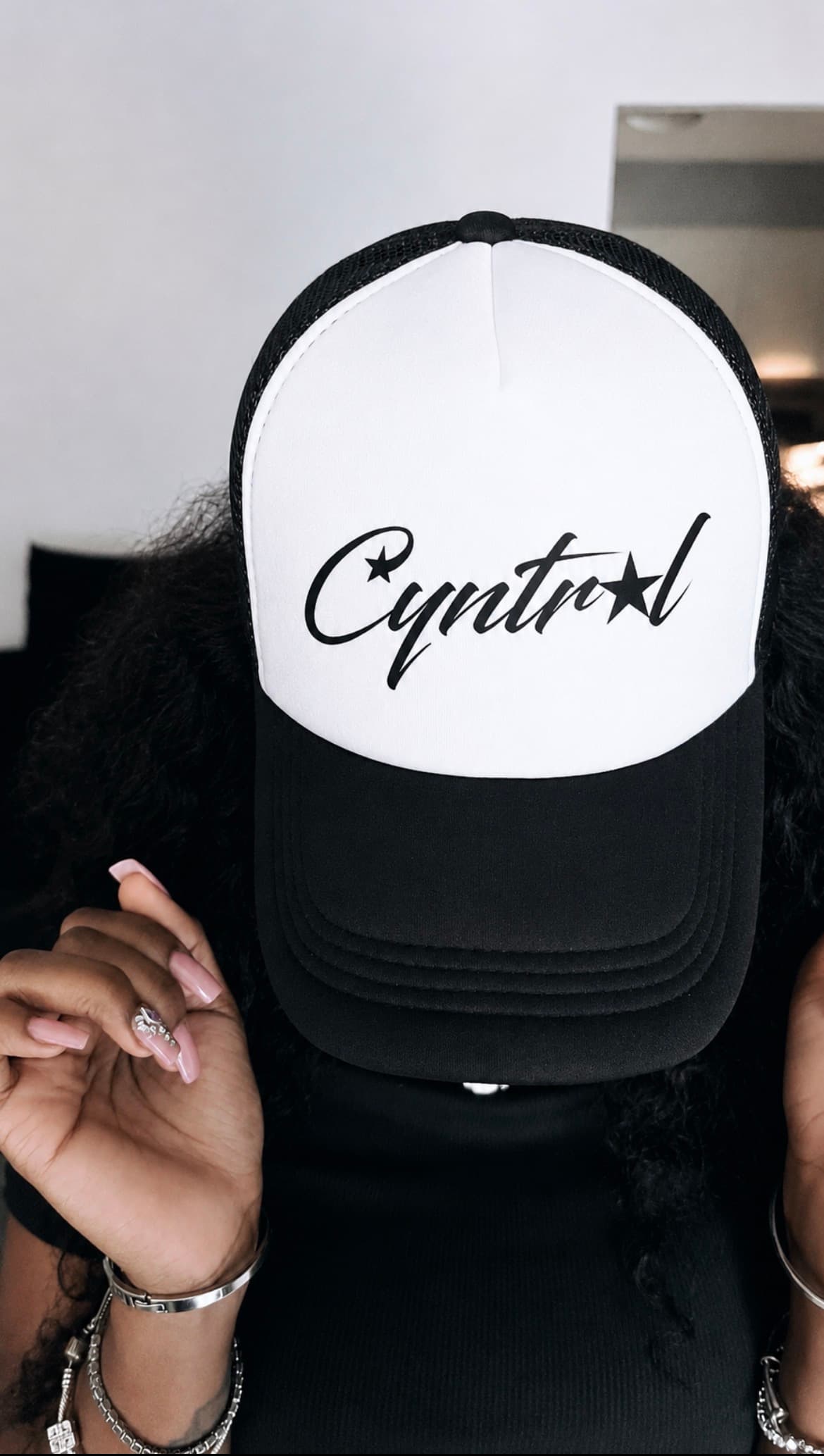 Portrait wearing a teal Cyntral cap